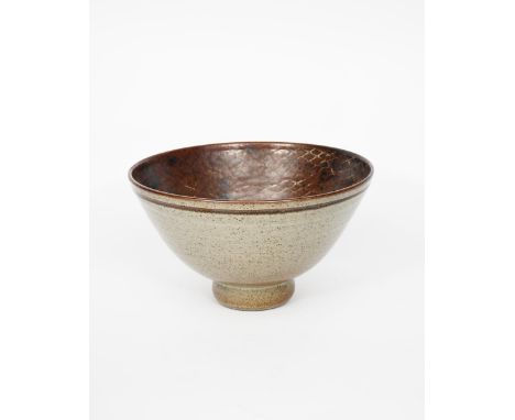 ‡ David Lloyd-Jones (1928-1994)  footed, flaring stoneware bowl, resist decorated to the interior with a net design in tenmok