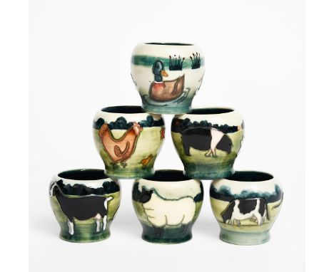 'Farmyard' a set of Moorcroft Pottery egg cups, the six egg cups each tubeline decorated with animals or birds in colours, in