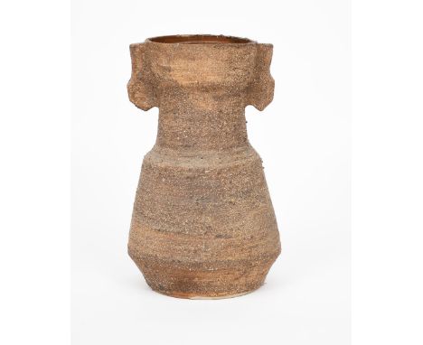 ‡ Janet Leach (1918-1997), manner of a stoneware vase with lug handles, shouldered form covered in a textured and pitted brow