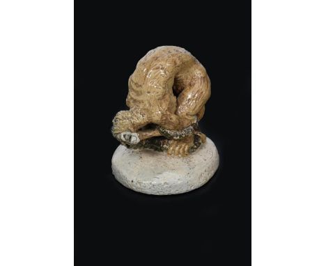 A Martin Brothers stoneware sculpture of a grotesque animal killing a snake by Robert Wallace Martin, dated 1890,  modelled o