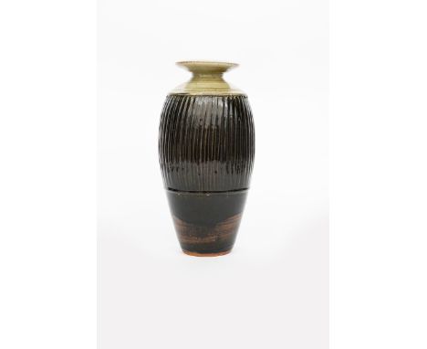 ‡ Richard Batterham (born 1936) a stoneware vase, shouldered form with flaring rim, the body vertical incised band, under ash