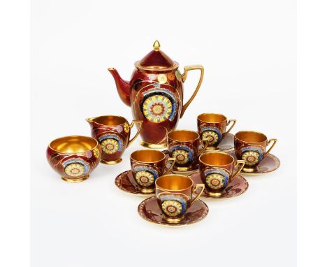 'Flower and Falling Leaf' a Carlton Ware coffee set for six, pattern no.3949, enamelled in colours and highlighted in gilt on