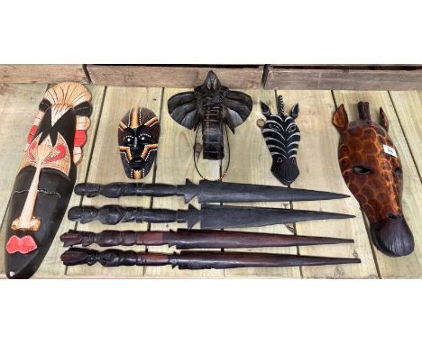 Selection of Five African tribal carved masks depicting animals along with carved tribal wood knives. 48cm largest mask. 