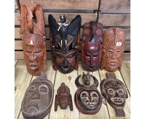 Selection of eight African tribal wall mount masks; ceremonial carved mask with beadwork design. 46cm largest. 
