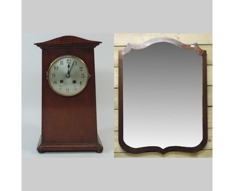 An early 20th century mahogany cased mantle clock, together with a wall mirror