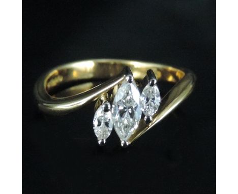 An 18 carat gold and marquise cut diamond cross over ring, by Christopher Wharton