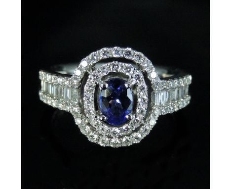 An 18 carat white gold diamond and tanzanite cluster ring