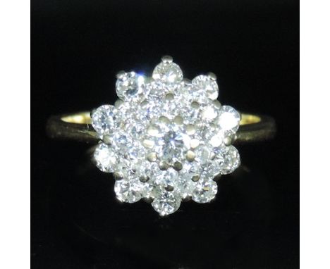 An 18 carat gold and diamond set cluster ring, boxed