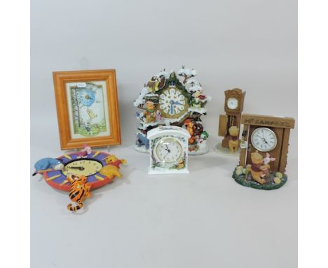 A Danbury Mint Winnie the Pooh cuckoo clock, 39cm tall, a Winter Wonderland clock and five others similar
