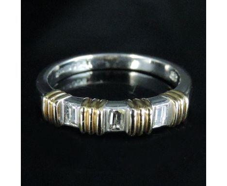 A two colour 18 carat gold and diamond three stone half hoop eternity ring