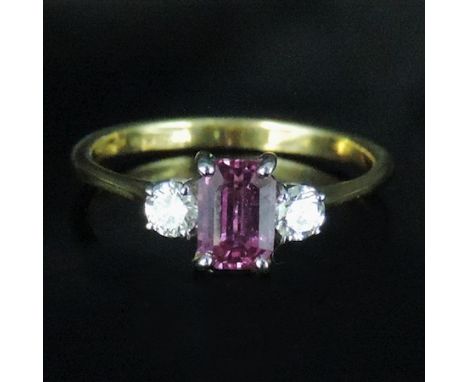 An 18 carat gold pink sapphire and diamond three stone ring