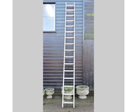 An aluminium extending ladder, in two sections, approx. 800cm overall