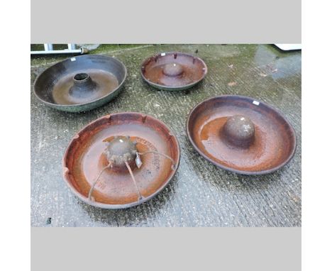 A cast iron circular pig trough, 76cm, together with three others