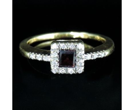 An 18 carat gold square set garnet and diamond cluster ring, boxed