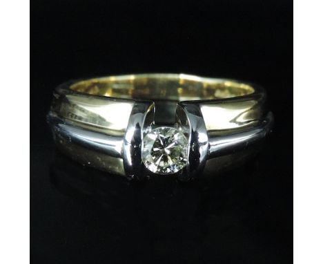 An 18 carat two colour gold ring, set with a single diamond, approx 0.25 carat, boxed