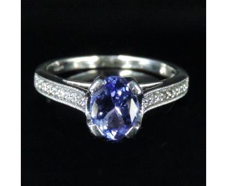 An 18 carat white gold diamond and tanzanite ring, boxed