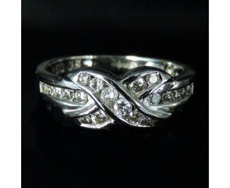 An 18 carat white gold and diamond crossover ring, boxed