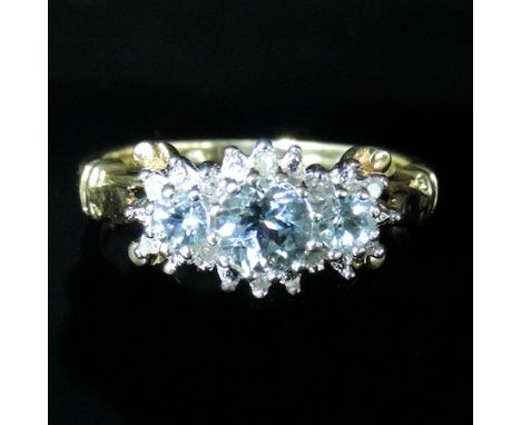 An 18 carat gold diamond and aquamarine ring, boxed