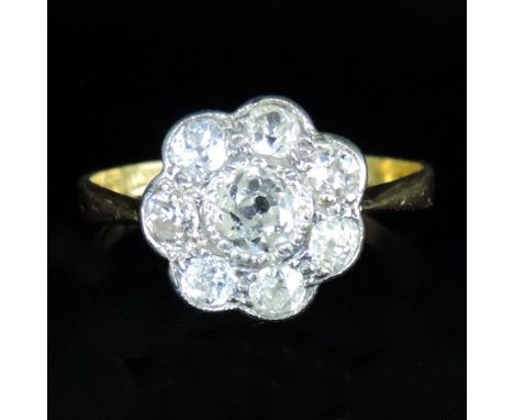 An 18 carat white gold daisy set diamond ring, approx. 1 carat, boxed