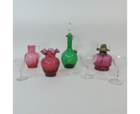 A Victorian cranberry glass oil lamp, together with other coloured glassware and two 18th century wine glasses