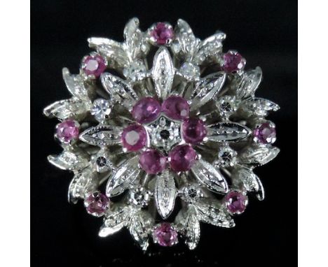 An 18 carat gold ruby and diamond cluster ring, boxed