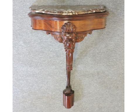 A 19th century French carved mahogany marble top console table on a scrolled support, 59cm