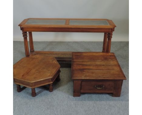 A modern glass top console table, 135cm, together with two hardwood coffee tables