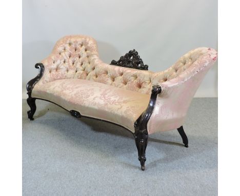 A Victorian carved mahogany and pink silk upholstered button back double ended sofa, on cabriole legs, 196cm