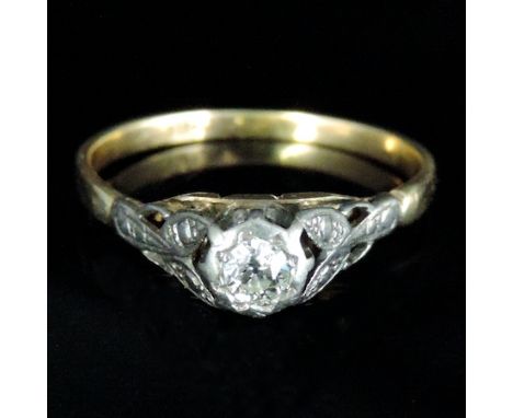 An 18 carat gold solitaire diamond ring, with textured shoulders