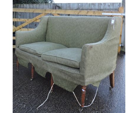 A 19th century green upholstered sofa, on reeded legs and castors, 140cm