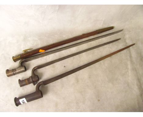 Three long socket bayonets, one with leather scabbard