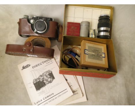 A Leica DBP camera, serial number 110121, in a black casing and a leather case, along with a Leica Ernst Leitz Wetzlar lens, 