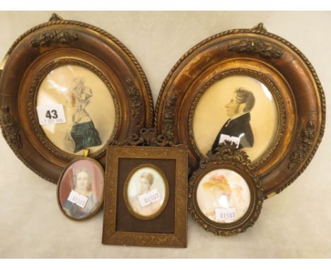 A selection of framed miniatures and Georgian silhouettes to include a small oval miniature portrait of a young girl in a blu