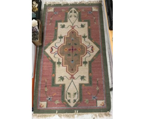 A pair of Kelim style rugs, the central panel set with floral decorated medallion on a pink ground within a green border, app