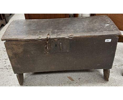 An early 18th Century provincial oak hutch or coffer, the single plank top with zigzag carved and notched ends, over plain fr