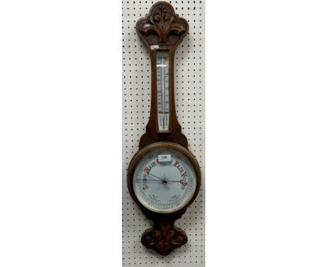A late Victorian carved oak cased aneroid barometer with mercury thermometer, 24 cm wide x 82 cm high