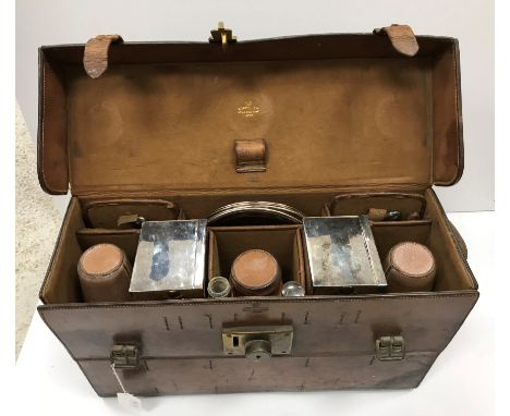 A vintage leather picnic case by or for W Thornhill & Co. 144 New Bond Street London, containing four plated plates, two larg