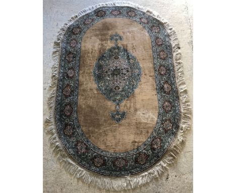 A Belouch rug, the central panel set with floral decorated medallion on a plain faun ground, within a stepped scrolling folia