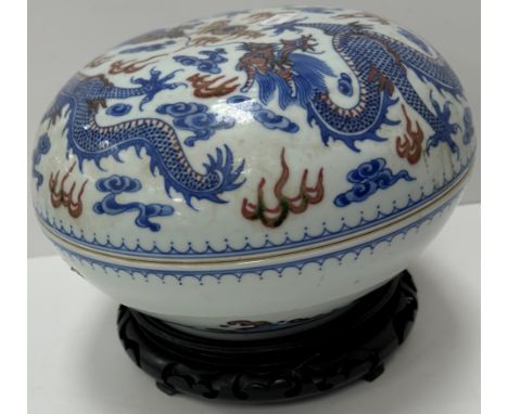 A Chinese circular lidded bowl with all-over five toed dragon and pearl decoration, the base with rough water decoration, rai