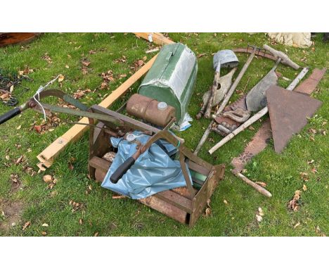 A collection of various vintage tools including silage knife, two handled saw, scythe, ladle, yoke, two large handsaws and lo