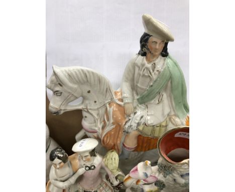 A collection of Staffordshire pottery flat back figures and spill vases including figure of "Harpist goatherd", "Scottish sta