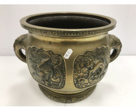 A Chinese brass jardiniere with relief panel decoration depicting dragon, turtle, phoenix and an other dragon flanked by styl