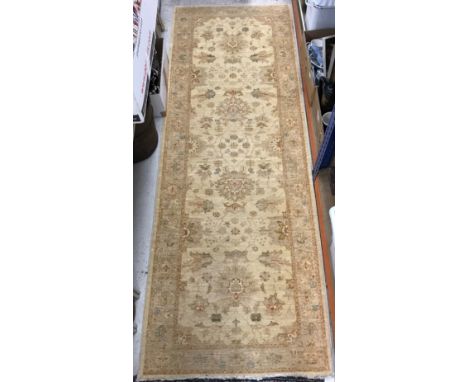 A modern Ziegler type runner, the central panel set with all-over scrolling floral design on a gold ground, within a stepped 