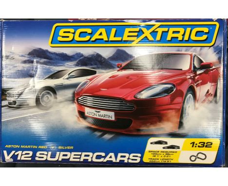 A collection of toys to include boxed Scalextric V12 Supercars set, Astin Martin red versus silver, a Hornby mainline stream 