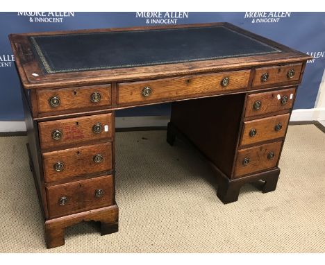 A Victorian oak double pedestal desk, the tooled and gilded leather insert top within a moulded edge over a central slim draw