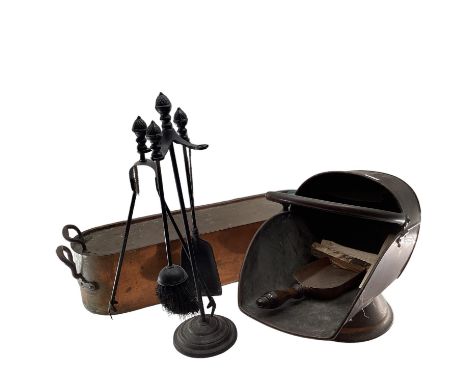 A collection of fireside items, tools and stand, Helmet shaped scuttle, fire screen, large copper fish kettle with Armorial N