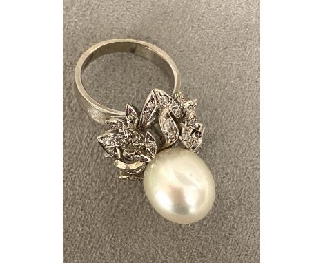 An 18c white gold, pearl and diamond ring, central single pearl, approx 12mm set with double surround of old cut diamonds, 12