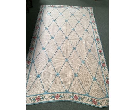 A modern, light coloured rug, bearing label David Douglas carpets, Wool, Portugal, with beige ground and all over blue diamon