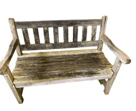 Two seater weathered garden bench, with a galleried ladder back 