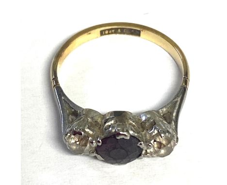 A ruby and diamond ring, central round cut ruby with old cut diamond accents, size K 